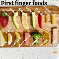 a wooden cutting board topped with different types of fruits and veggies on it