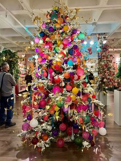 a brightly colored christmas tree in a store