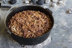 a pan filled with granola sitting on top of a counter next to a spatula