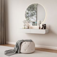 a round mirror sitting on top of a white shelf