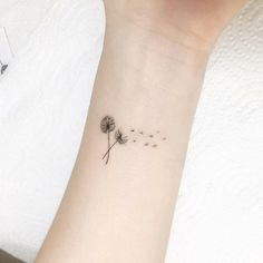 a small dandelion tattoo on the wrist