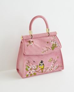 Key Features    Chic Spring Style: Embrace the essence of Spring with our Bird Embroidered Mini Tote, featuring nature-inspired embroidery and plush velvet finish.   Versatile Carryall: Perfect for any occasion, from workdays to special outings, ensuring you're prepared with effortless style.   Practical Design: Includes a convenient chain strap and secure popper fastening for easy access and peace of mind.   Compact Yet Spacious: Ample room for all essentials, measuring approximately 20cm L x 18cm H x 6cm W.   Dimensions    Imperial: Approx. 7.9" L x 7.1" H x 2.4" W   Metric: Approx. 20cm L x 18cm H x 6cm W   Materials   Outer: Velvet  Lining: 100% Polyester   Care   Clean with a damp cloth to maintain the pristine condition of the velvet and polyester lining. Chic Spring Style, Spring Time Outfits, Spring Fashion Chic, Morning Songs, Luxury Christmas Gifts, Mini Pink, Diy Tote Bag, Pink Tote, Pretty Bags