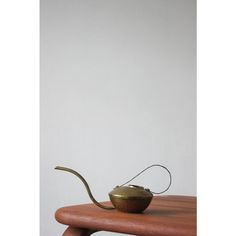 a teapot sitting on top of a wooden table