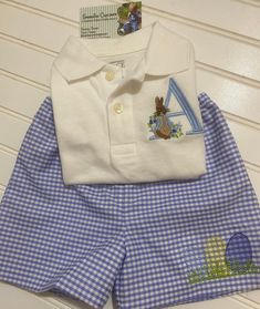 Boy's Peter Rabbit Easter Outfit The perfect outfit for Easter, pictures and the big Easter egg hunt. This adorable set has a polo shirt with an embroidered Peter Rabbit with the initial of your choice. The blue gingham shorts are completely lined, with an elastic waist and Easter eggs embroidered on the leg. Please put the letter you would like in the space provided. Cute Cotton Sets For Easter, Preppy Cotton Sets For Spring, Preppy Fitted Cotton Sets, Preppy Cotton Spring Sets, Spring Preppy Cotton Sets, Peter Rabbit Easter, Boys Easter Outfit, Holiday Sewing, Easter Pictures