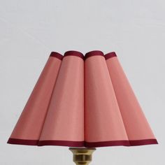 a pink lamp with three shades on it