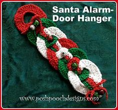 a crocheted santa alarm door hanger on a green blanket