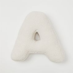 a white pillow shaped like the letter a