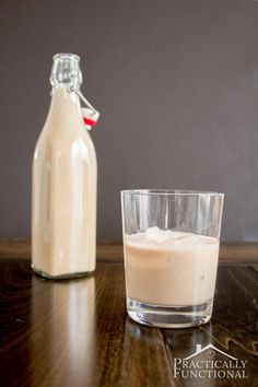 a bottle of milk next to a glass on a table