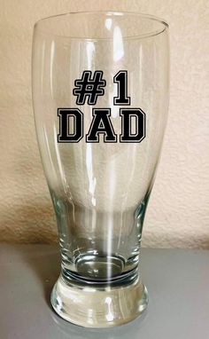 a glass with the words 1 dad printed on it