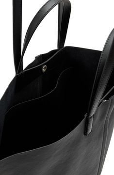 Bring it all with you—we're talking your essentials, laptop and an extra layer for unpredictable weather—with this leather tote crafted with winged gussets that enhance its carrying capacity. You can hold it in hand with the top handles or sling it over your shoulder with the longer straps when it's packed to the max. Top snap closure Top carry handles; shoulder straps Interior wall pocket Leather lining Leather Imported Fabric Gift Bags, Interior Wall, Wall Pockets, East West, Bring It, Nordstrom Store, Fabric Gifts, Free Fabric, All Saints