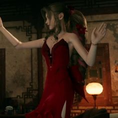 a woman in a red dress is dancing with her arms spread out to the side