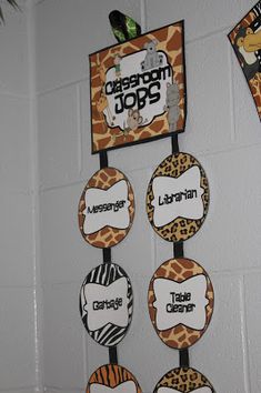 a classroom decoration with giraffes, zebra print and name tags on it