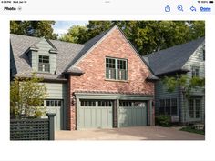 an image of a brick house with two garages