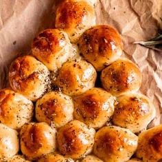 a pile of bread rolls sitting on top of a piece of wax paper