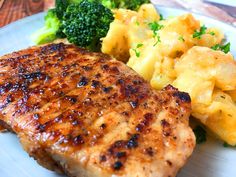 a plate with meat, potatoes and broccoli on it that is in a frame