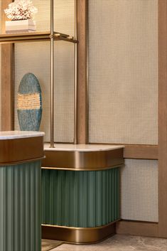 a bath tub sitting next to a shelf with a vase on top of it in a bathroom