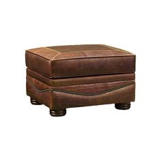 a brown leather ottoman sitting on top of a white floor