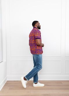 Style# M2080PTA Introducing the Femi Men's African Print Polo in Purple Tangerine Adire. This vibrant short-sleeved design features an African-inspired pattern in a range of bold colors, perfect for standing out in any outfit. Dress it up with slacks or dress it down with sneakers and jeans for casual settings. Shop matching items here. Description Short Sleeve Polo Vents at Sides 95% Cotton/5% Spandex body with 100% Cotton rib knit Designed in the US, imported Care Instructions Machine wash col Casual Purple Half Sleeve Tops, Multicolor Fitted Collared T-shirt, Fitted Multicolor Collared T-shirt, Fitted Collared Multicolor T-shirt, Fitted Multicolor Short Sleeve Shirt, Casual Purple Short Sleeve Shirt, Purple Relaxed Fit Collared Shirt, Purple Fitted Short Sleeve Top, Purple Fitted Collared Polo Shirt