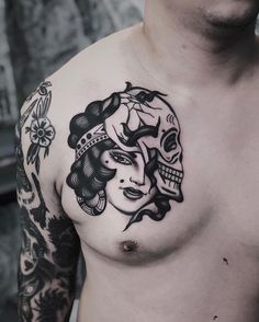 a man with a tattoo on his chest has a woman's face in the middle