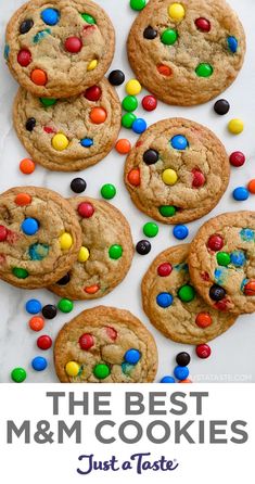 A top-down view of M&M cookies studded with a rainbow of M&M's. Mint M And M Cookies, M&m Cookies Soft, M M Mini Cookies Recipe, Soft Batch M&m Cookies, Homemade M&m Cookie Recipe, Cookies Recipes M&m, How To Make M&m Cookies, Mini Mnm Cookies Recipe, Subway M&m Cookie Recipe