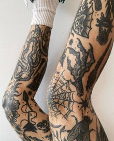 a man with tattoos on his arms and legs