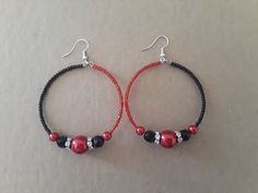 Beaded hoop earrings that I made using black and red seed beads, red pearls, black beads, and diamond spacers. Hoops are 3 inches in length, and a little over 2 inches in width... Back in stock  Earrings are lightweight and fun to wear, will definitely stand out! Thanks for looking..🙂 Black Hoop Earrings With Colorful Beads For Gift, Black Hoop Earrings With Colorful Beads As Gift, Gift Black Hoop Earrings With Colorful Beads, Red Colorful Beads Hoop Earrings, Red Hoop Earrings With Colorful Beads, Red Beaded Round Hoop Earrings, Adjustable Red Beaded Earrings With Black Beads, Red Beaded Earrings With Black Round Beads, Red Hoop Earrings With Colorful Beads For Jewelry Making