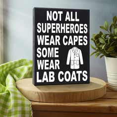 a sign that says not all superheros wear capes some wear lab coats on it