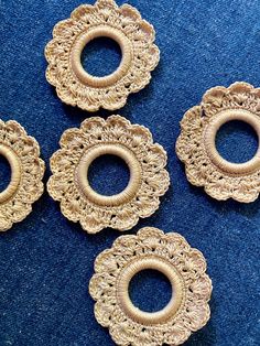 four pieces of brooch sitting on top of a blue cloth