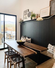 a dining room table and chairs in front of a sliding glass door