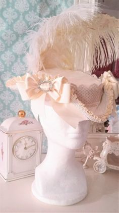 Marie Antoinette/ Rococo (or Late Baroque) Style Ladies Tricorn Riding Hat in Cream satin on cream cotton twill w/ tiny Fleur De Lis Print and box pleatee satin ruffle trim, edged with ivory gimp. This piece is wrapped in antique style ivory cotton ribbon with tiny taupe dots. Both sides of this hat are saddled with beautiful ivory satin ribbon bows enclosed in rhinestone buckles Topped with the softest ivory and white Ostrich plumes. This hat is 11.5 inches from end to end with a generous 6.5 i Elegant Curved Brim Hat For Costumes, Elegant Short Brim Costume Hat, Elegant Wide Brim Costume Hat, Elegant Brimmed Mini Hat For Costume Party, Elegant Mini Hat With Curved Brim For Costume Party, Elegant Costume Hat With Curved Brim, Elegant Curved Brim Costume Hat, Elegant Curved Brim Hats For Costume Party, Rococo Hat