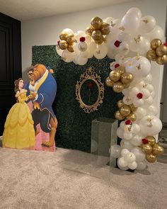 the balloon arch is decorated with gold, white and red balloons for a beauty and the beast themed birthday party