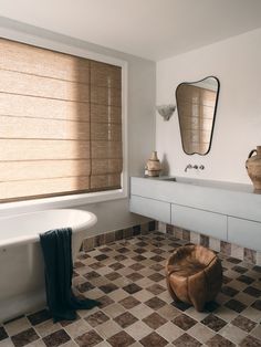 a bath room with a tub a sink and a mirror on the wall in it