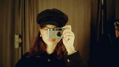 a woman taking a selfie in front of a mirror with a camera on her head