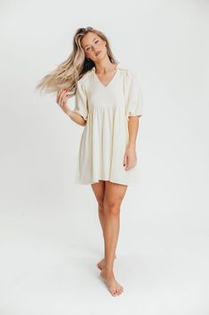 The feeling of cool, crisp cotton against your skin will keep you reaching for this gorgeous mini dress over and over as the temps rise. Featuring a beautifully tailored collared neckline and 1/2 length balloon sleeves, the Tiffany dress is crafted from a luxuriously soft 100% cotton gauze. Pair this beauty with everything from sandals to pumps to Sambas - there's no bad styling with the Tiffany dress. FIT: Runs true to size - relaxed fit. MATERIAL: 100% Cotton. GARMENT DETAILS: Lightweight summ Summer Cream Dress With Balloon Sleeves, Summer Cream Balloon Sleeve Dress, Cream Balloon Sleeve Summer Dress, Summer Balloon Sleeve Mini Dress For Daywear, Feminine Summer Mini Dress With Balloon Sleeves, Feminine Mini Dress With Balloon Sleeves For Summer, Brunch-ready Puff Sleeve Linen Dress, Feminine Cream Mini Dress With Puff Sleeves, Cotton Mini Dress With Balloon Sleeves