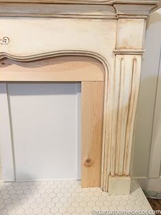 an old fireplace with white paint and wood