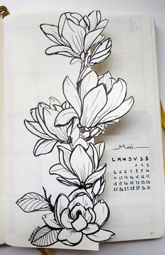 an open notebook with flowers drawn on it