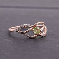 "Peridot ring, Cute ring, Multistone ring, Fine ring, Twist ring, Birthstone ring, Gemstone ring, Custom stone ring, Personalize ring WE OFFER UNLIMITED PERIOD INSTALLMENTS PLAN This is a beautiful, stunning, feminine ring that works well for all occasions, styles, and ages. You will love it! Ring information: Main stone: Peridot Approximate size: 3mm Approximate weight: 0.13ct Accent stone: Cubic zirconia Metal type: Gold Metal stamp: 14k Gold Customization / Replacements It's easy to create je Green Cubic Zirconia Round Band Rings, Gemstone Bypass Promise Ring, Green Gemstone Promise Ring, Green Crystal Round Promise Ring, Green Open Cluster Ring For Promise, Green Round Crystal Promise Ring, Green Gemstone Cluster Open Ring, Emerald Promise Ring With Stone Setting, Diamond Ring With Center Stone For May Birthstone