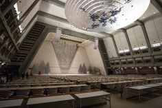 an empty auditorium with tables and chairs in it