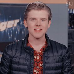 a young man wearing a jacket and tie