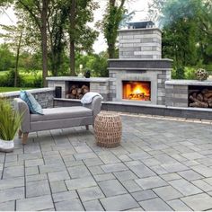 an outdoor fireplace and seating area is shown