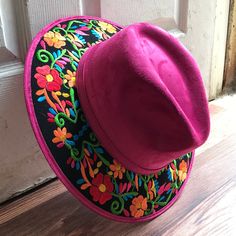 Stand out with this beautiful handcrafted Mexican Suede Hat with beautiful detailed floral embroidered canvas brim. Perfect accessory to add that with that daily outfit. MADE IN MEXICO By: Mexican Artisans For: Women Size: Medium 23' Color: magenta | black | multi Details: Top Suede Embroidered canvas brim Inner elastic band Contact us for more details PLEASE READ BEFORE PURCHASE: The picture is an ACCURATE REPRESENTATION.Colors in the pictures may vary a little by effects of light. Each product Cheap Embroidered Red Hats, Artisan Wide Brim Felt Hat For Spring, Embroidered Festival Cap, Embroidered Cap For Festival, Spring Artisan Wide Brim Felt Hat, Bohemian Flat Brim Felt Hat For Spring, Multicolor Embroidered Festival Hats, Bohemian Spring Felt Hat With Flat Brim, Bohemian Embroidered Festival Hat