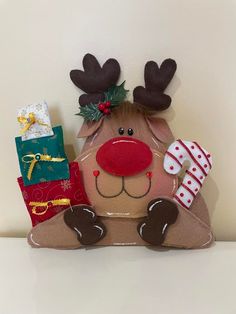 a stuffed reindeer sitting on top of a shelf