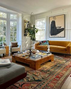 a living room filled with furniture and lots of windows