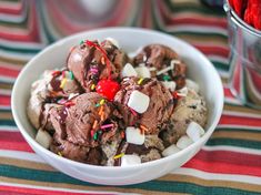 a bowl filled with ice cream and sprinkles on top of a table