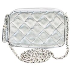 - Vintage Chanel silver metallic quilted lambskin shoulder bag from year 1996 to 1997. - Silver metallic lambskin with silver hardware "CHANEL” zip closure. - Silver hardware chain with silver metallic lambskin shoulder strap. - Silver metallic lambskin interior. - one Interior zip pocket and one slip pocket. - Comes with authentic card, serial sticker, booklet and dust bag. - Size: 16cm x 10cm x 6 cm. Drop: 59 to 60 cm approximately. Bag Silver, Vintage Chanel, Fashion Handbags, Silver Hardware, Metallica, Metallic Silver, Zip Pockets, Chanel, Dust Bag