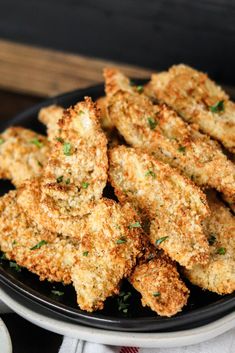 air fryer crispy artichokes on a black plate with parsley