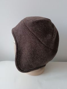 Italian wool hat/ boiled wool Jersey. Unisex Earflap winter hat Hight quality knitted wool jersey fabric with soft felted face side.Double sided wool fabric. Earsflap part double layered. Warm winter hat Brown face side/ soft Grey inside Hat Size: S / inch 21 1/4 - 21 5/8 * metric  54-55cm M/ inch 22-22 3/8 * metric 56-57 cm  L/ inch 22 3/4 - 23 1/8 * metric 58-59 cm XL/inch 23 1/2 - 24 * metric 60-61cm 2X/ inch 24.4 - 24 5/8 * metric 62-63 cm Wool 68% poliester 23 % acril 9% Gentle machine or hand washable. Handmade to the order Shipping by Priority Air Mail or use shipping upgrades for Fedex shipping