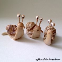 three snails with googly eyes sitting next to each other