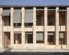 an apartment building with several windows and shutters