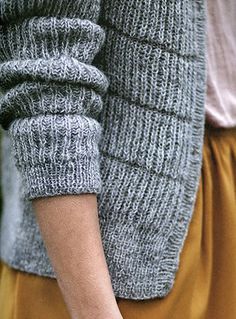 two people are holding hands with each other while wearing sweaters and yellow skirtes